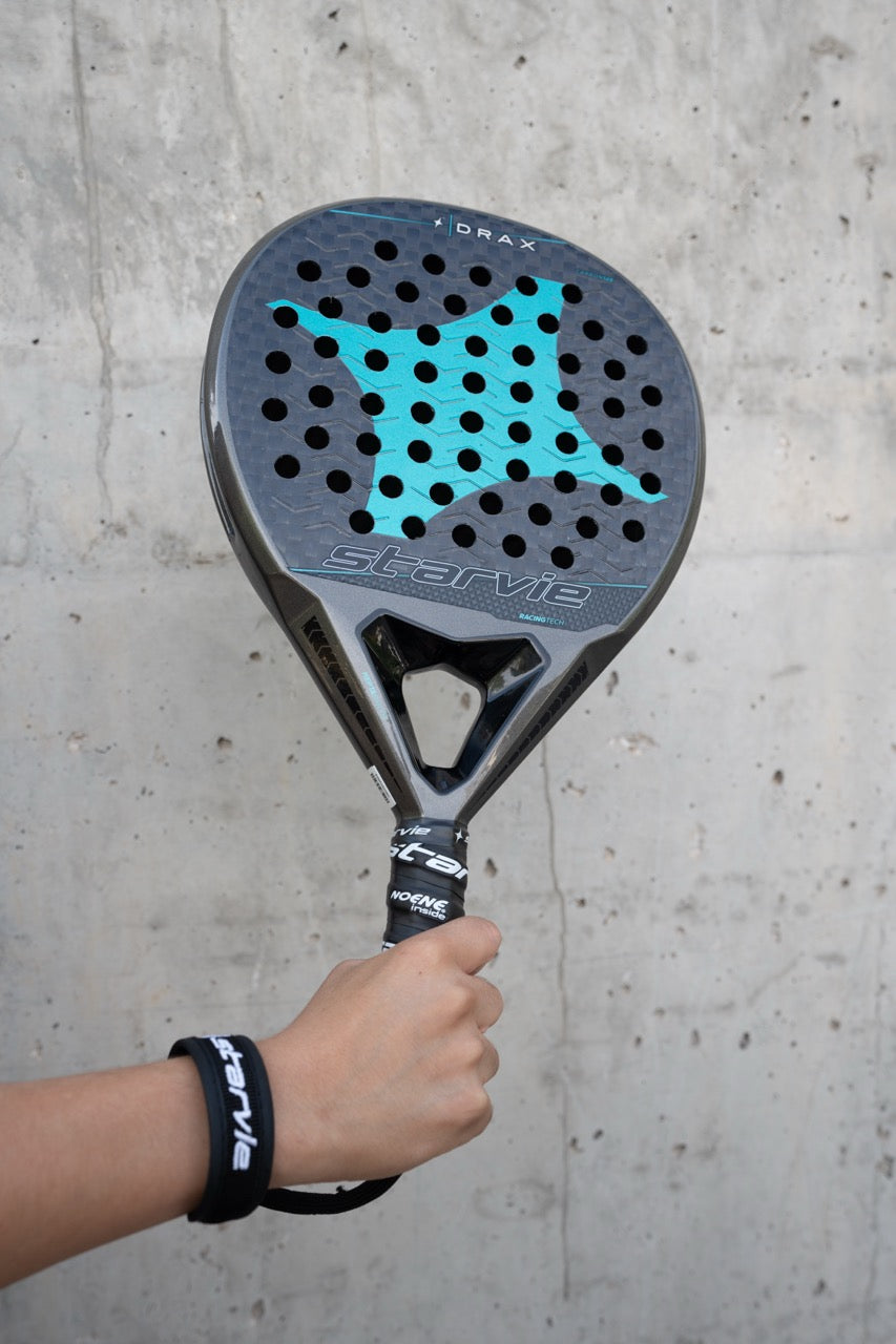 Padel player holding the StarVie Drax Pro Touch padel racket, showcasing its ergonomic design and high-quality materials.