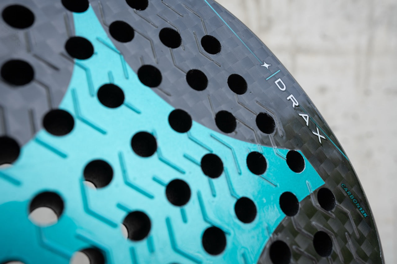Close-up of the StarVie Drax Pro Touch racket’s carbon 12K textured surface for enhanced spin and ball control.